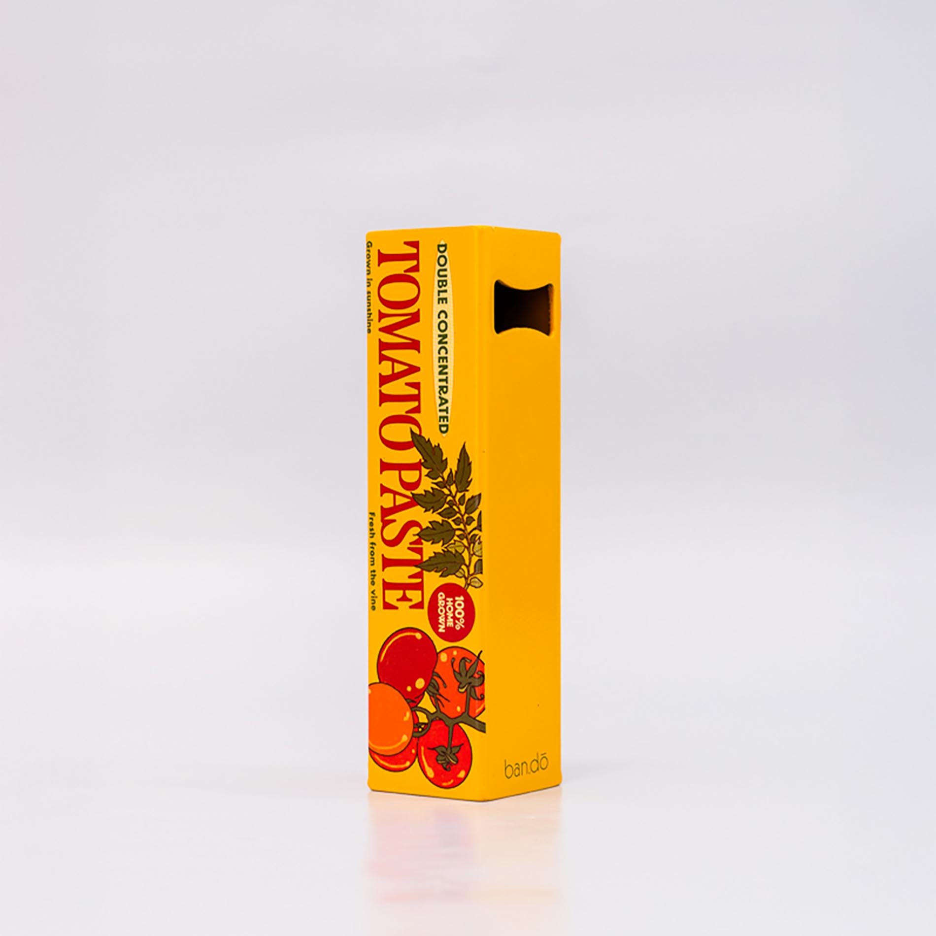 Yellow box of tomato paste bottle opener with red tomatoes on a white background