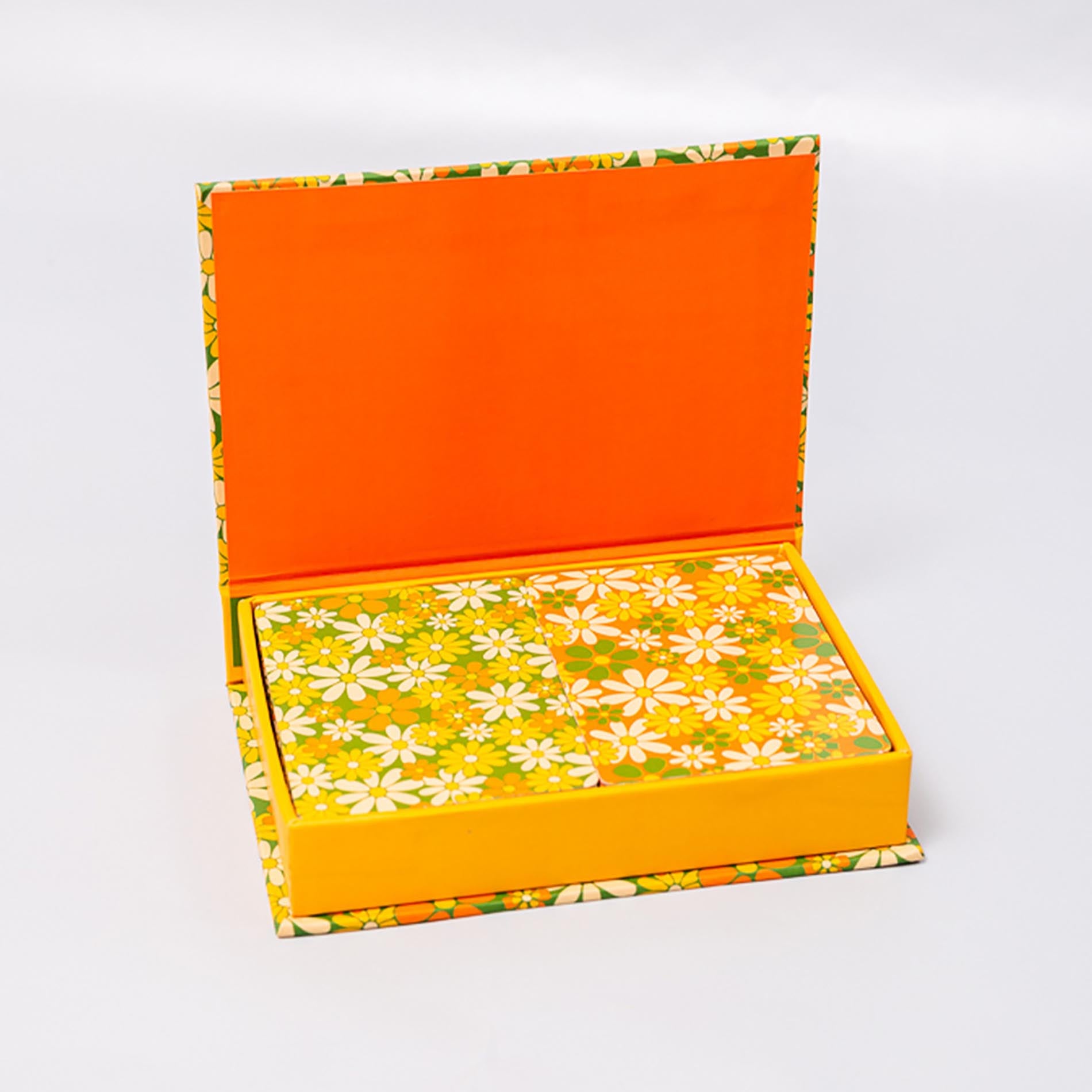 Open box with orange top and floral-patterned bottom on a white background