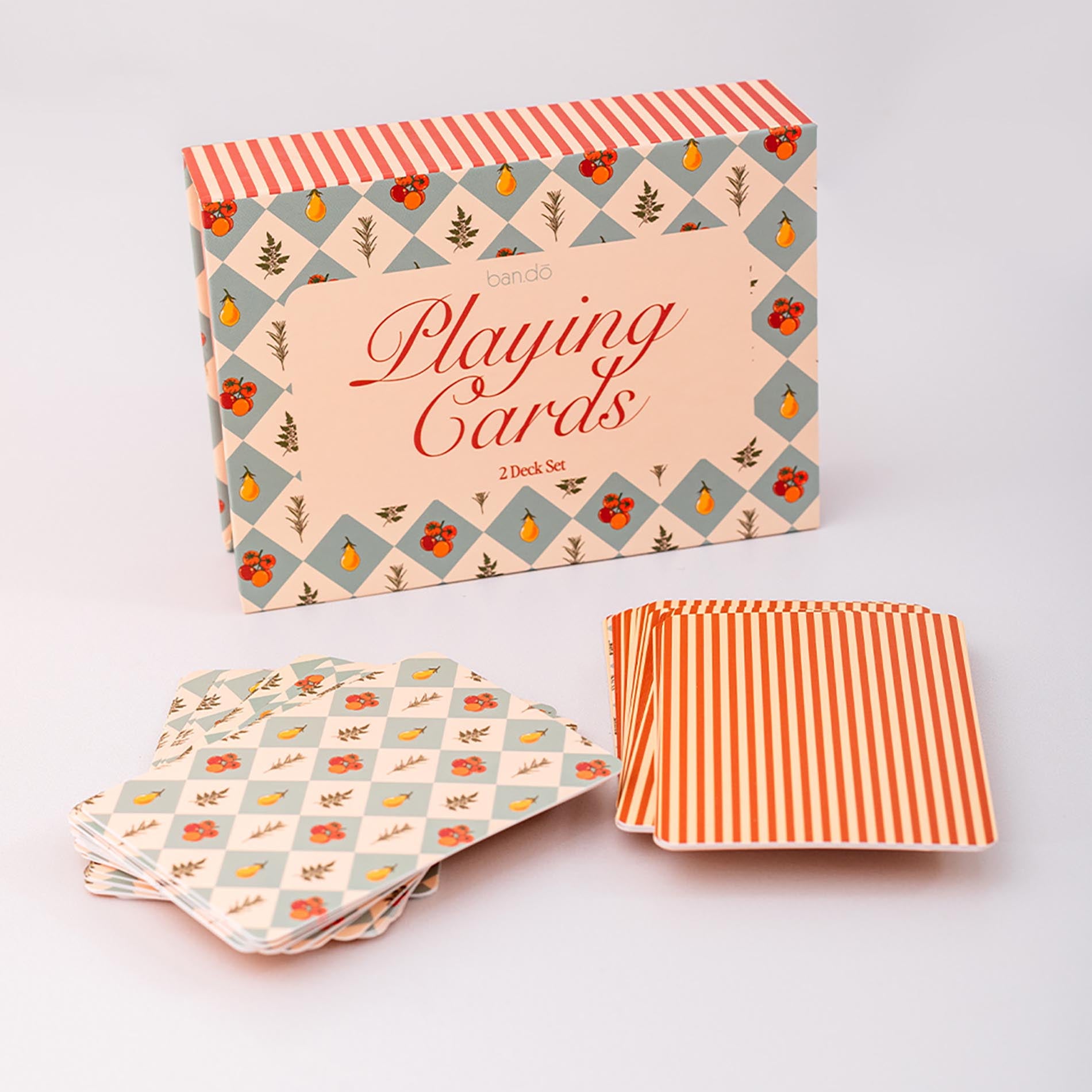Playing card set with floral and striped design on a light gray background