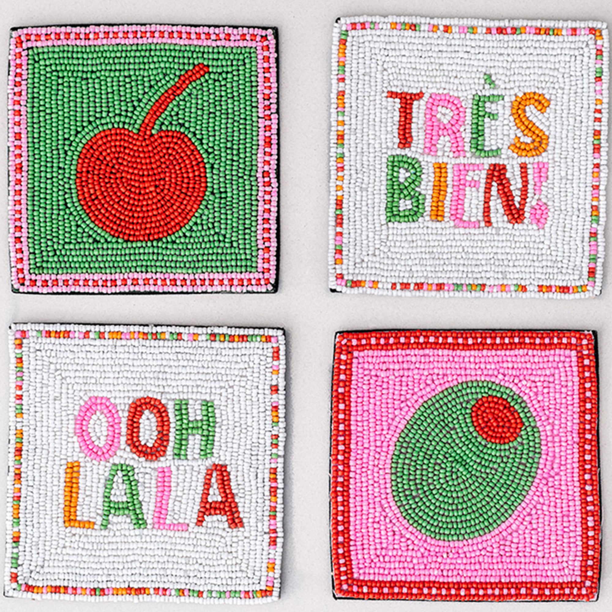Four colorful coasters with text and graphics on a white background