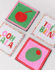 Four colorful coasters with text and designs on a light gray background