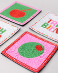 Colorful embroidered coasters with various designs on a light gray surface