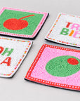 Four colorful coasters with text and designs on a gray background