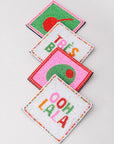 Four colorful coasters with text and designs on a light gray background