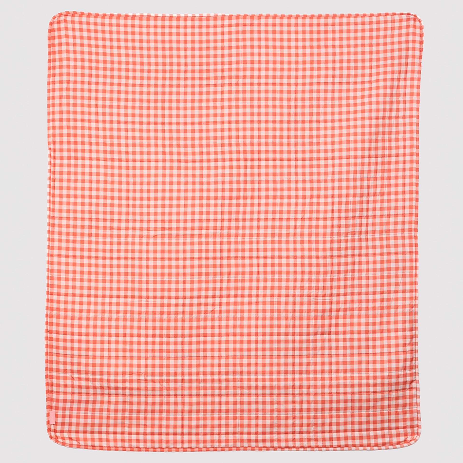 Red and white checkered fabric on a light gray background