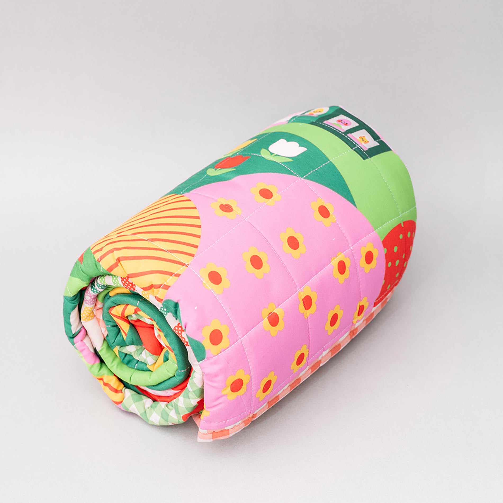 Colorful quilt with strawberry pattern on a gray background