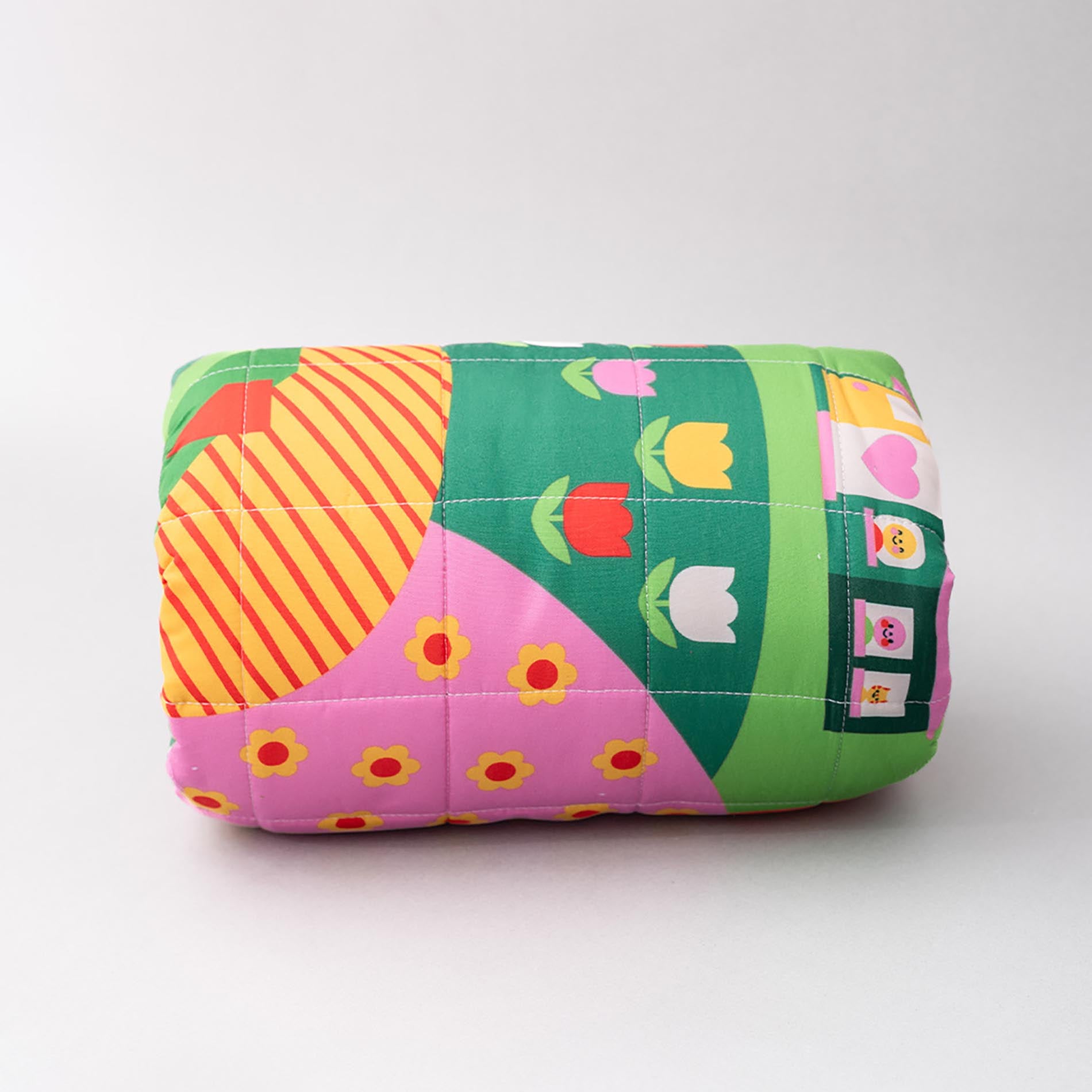 Colorful quilt with geometric patterns on a white background