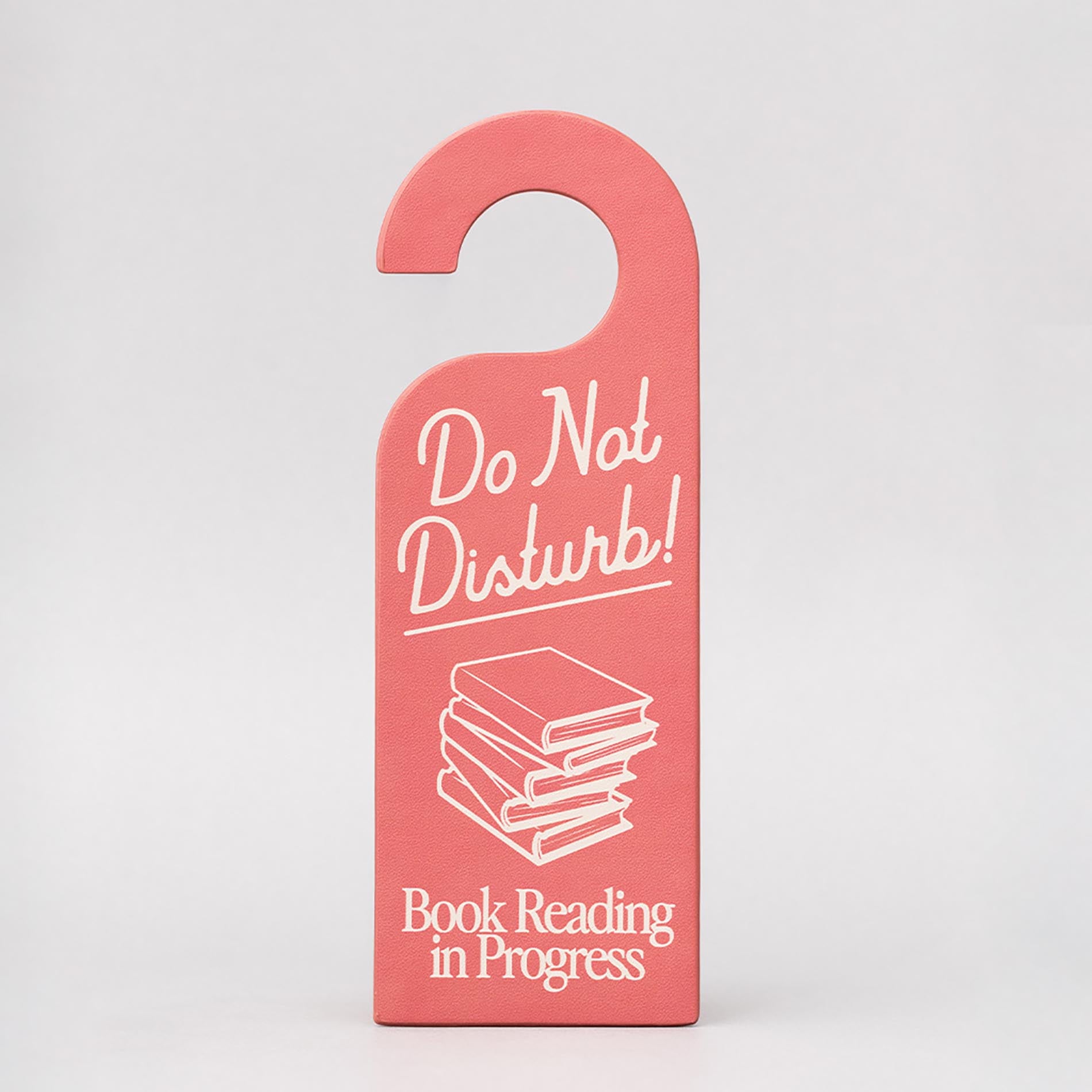 Pink door hanger bookmark with 'Do Not Disturb! Book Reading in Progress' text on a gray background