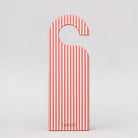 Red and white striped door hanger with 'bando' branding on a light gray background