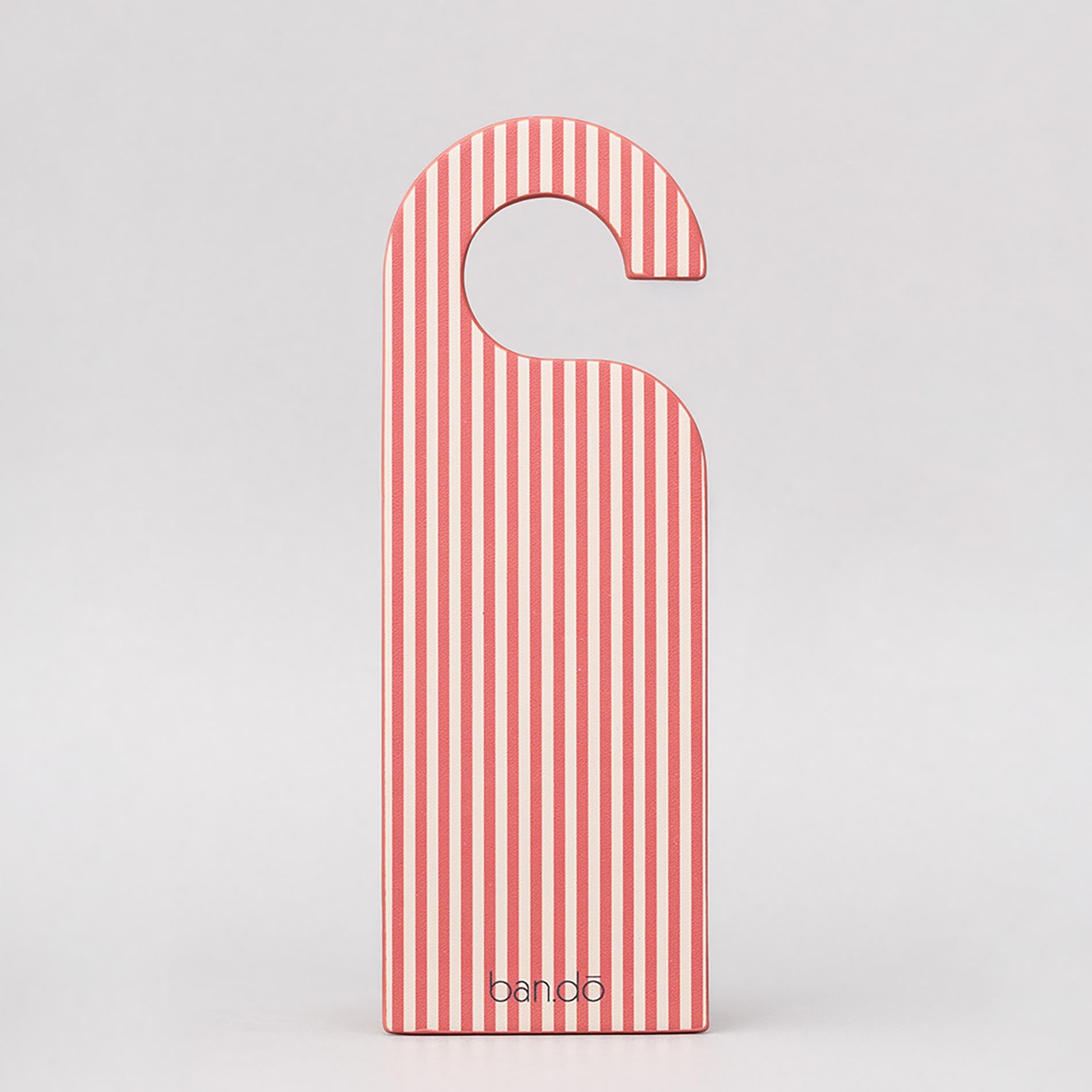 Red and white striped door hanger with 'bando' branding on a light gray background