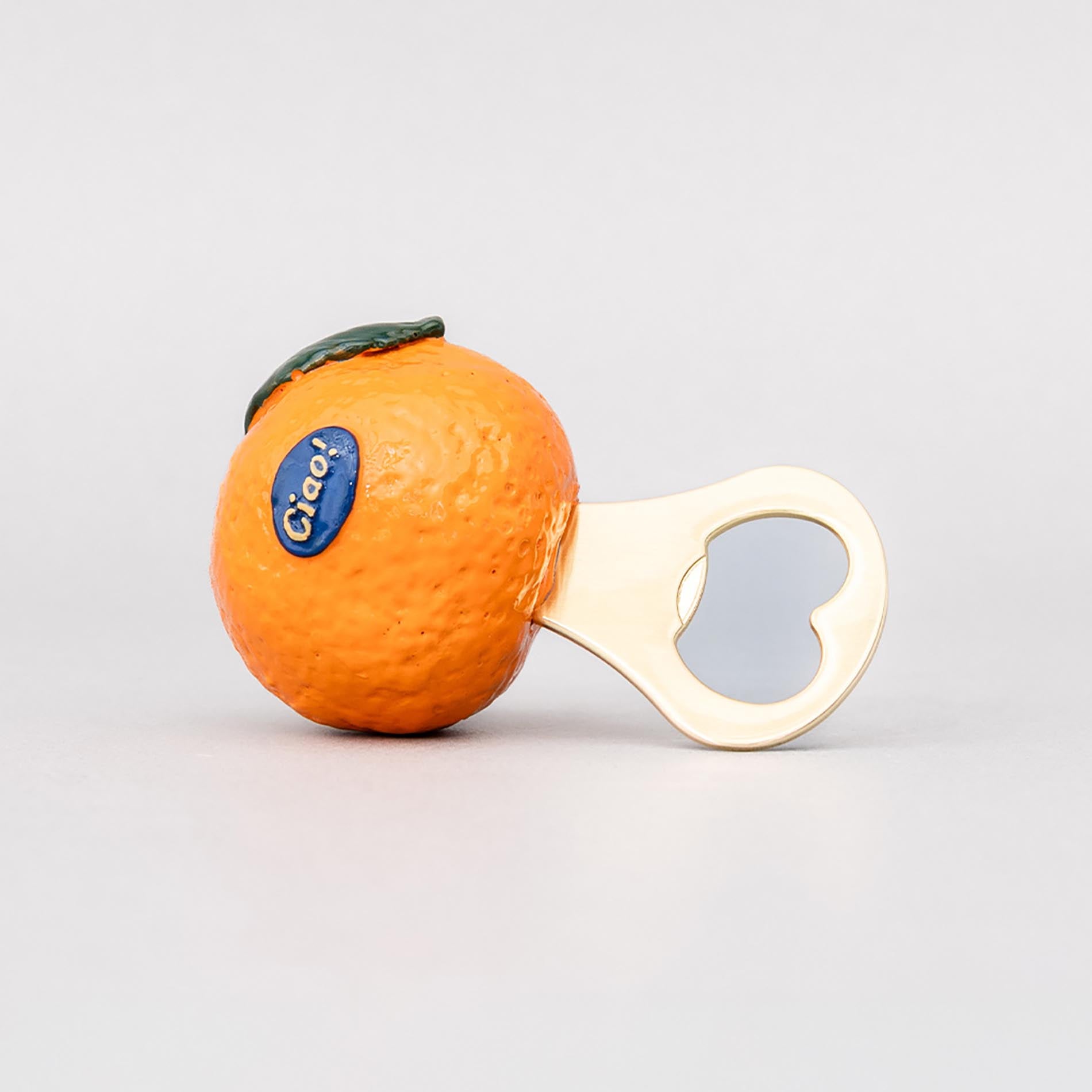 Orange-shaped bottle opener with a heart design on a light gray background