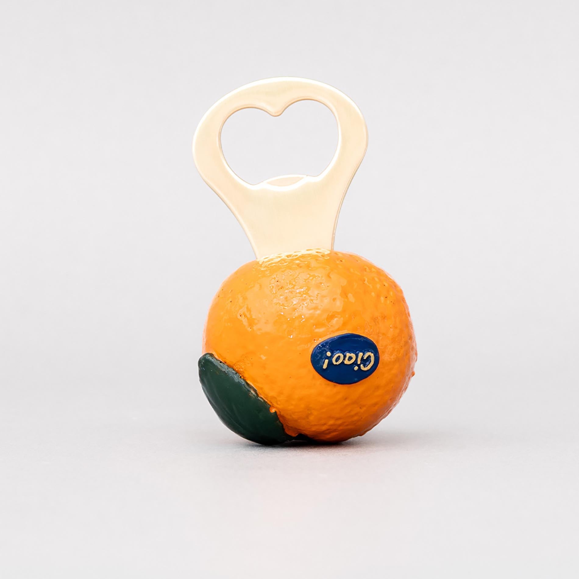 Orange-shaped bottle opener with a heart-shaped handle on a light gray background
