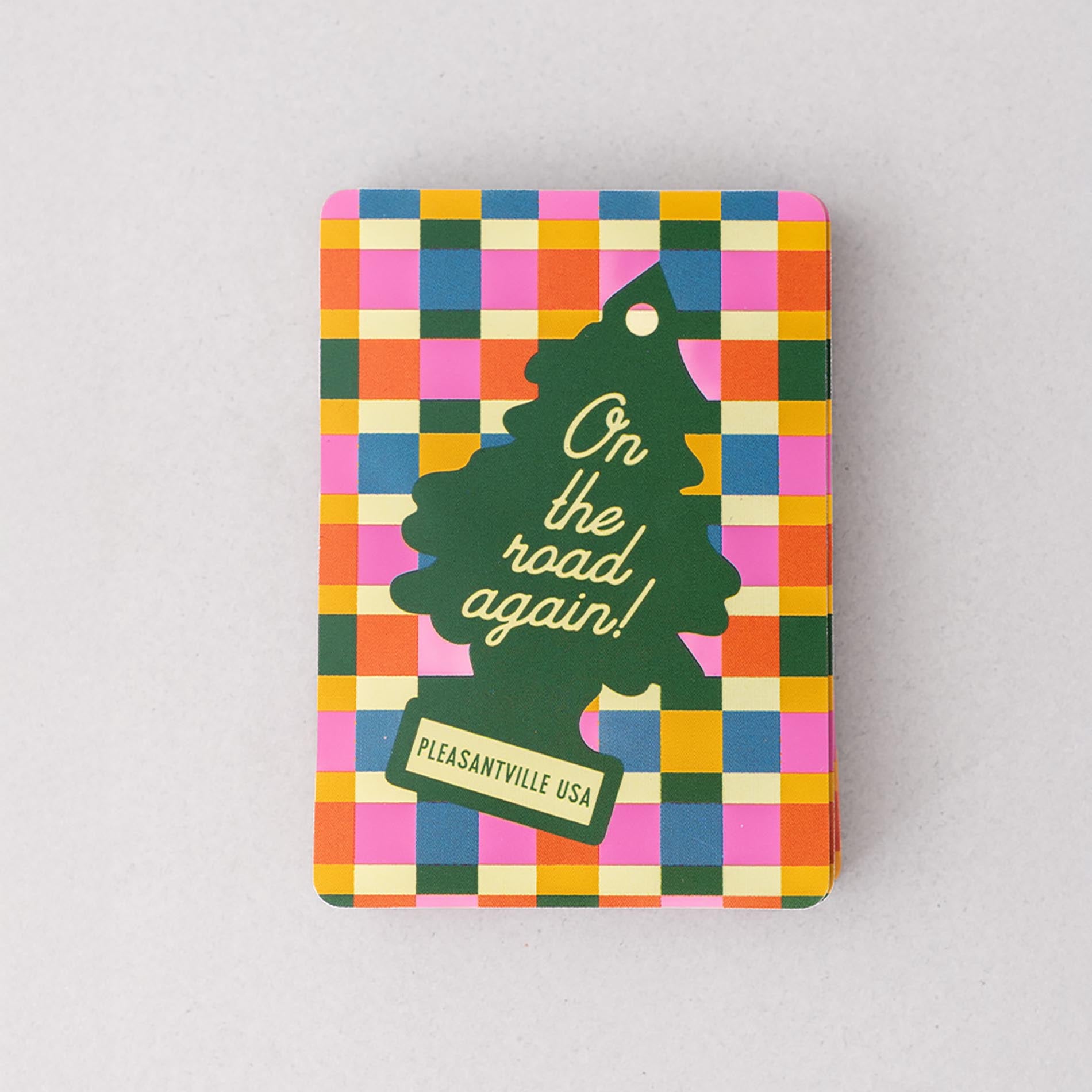 Colorful checkered tin with a green tree design and text on a gray background