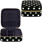 Black jewelry case with white polka dots and gold zipper, open to reveal compartments.