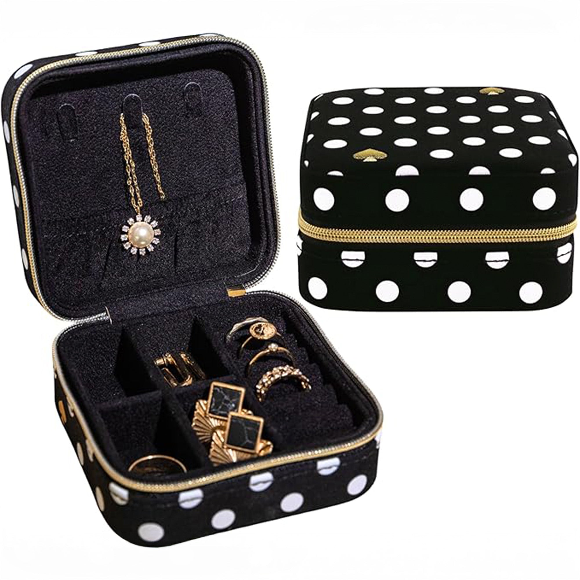 Black jewelry case with white polka dots containing gold jewelry, next to a matching black and white polka dot case.