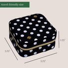Black polka dot travel-sized product case with measurements on a beige background