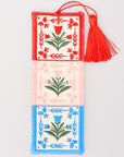 Decorative bookmark with floral patterns and a red tassel on a light gray background