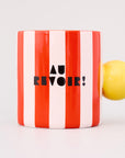 red and white vertical stripe mug with yellow ball handle and double sided typography with 'BONJOUR!' on one side and 'AU REVOIR' on the other