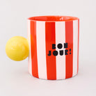 red and white vertical stripe mug with yellow ball handle and double sided typography with 'BONJOUR!' on one side and 'AU REVOIR' on the other