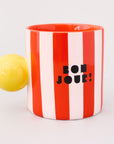 red and white vertical stripe mug with yellow ball handle and double sided typography with 'BONJOUR!' on one side and 'AU REVOIR' on the other