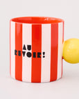 red and white vertical stripe mug with yellow ball handle and double sided typography with 'BONJOUR!' on one side and 'AU REVOIR' on the other
