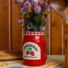 side view of strawberry jam petite ceramic vase with a bouquet in the top