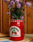 side view of strawberry jam petite ceramic vase with a bouquet in the top