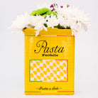 yellow pasta box vase with flowers inside