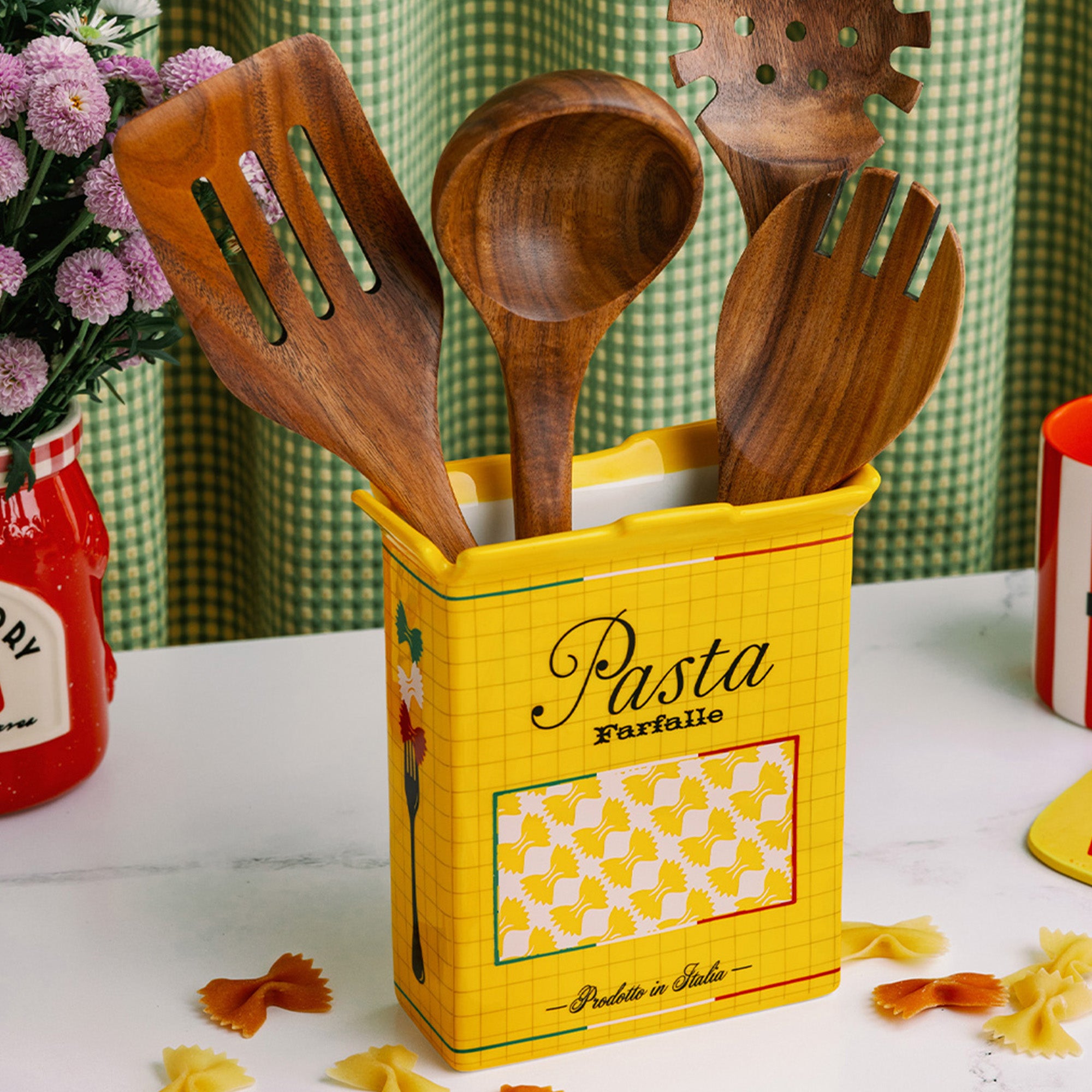 yellow pasta box vase  with wooden utensils inside