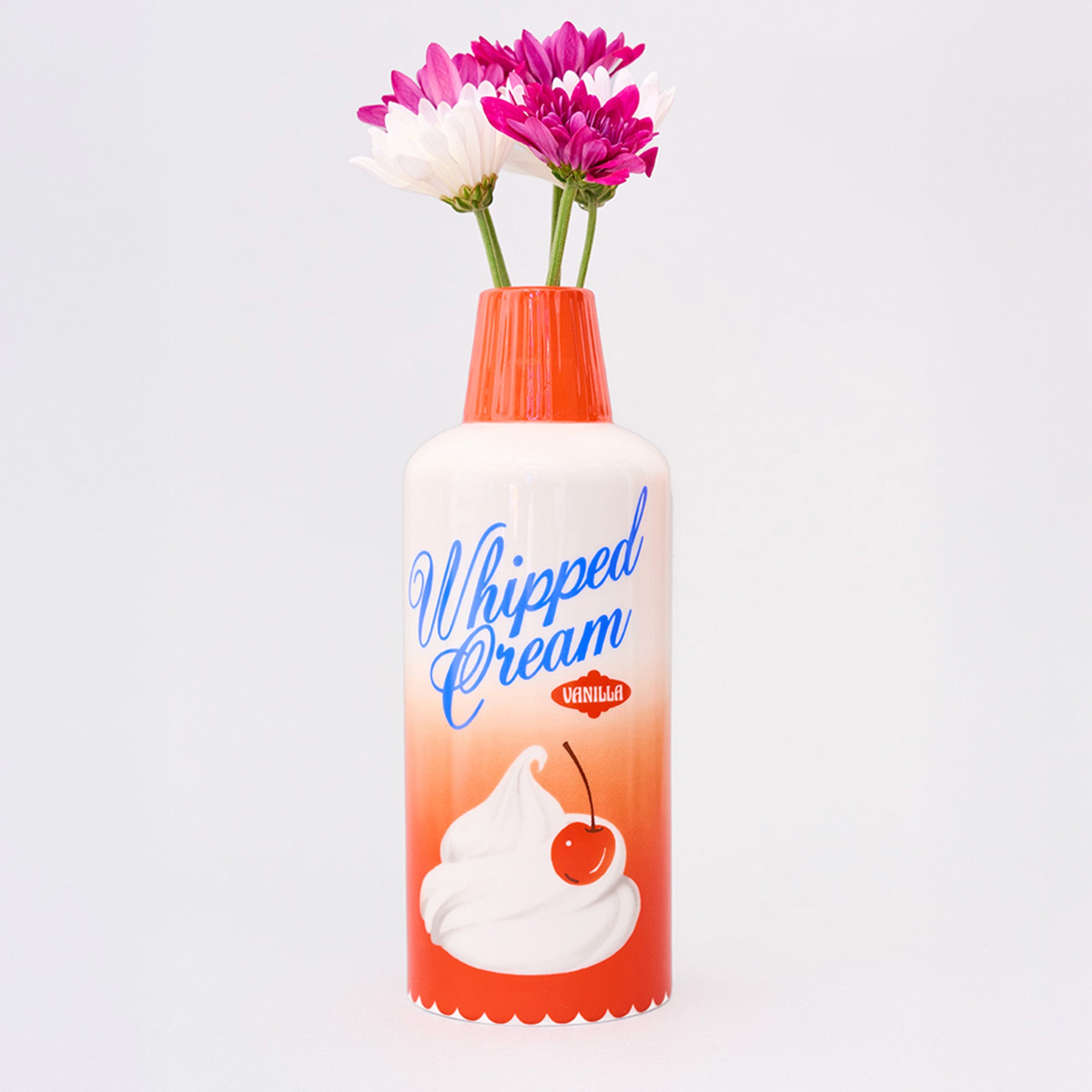 whipped cream ceramic vase with flowers in the top