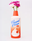 whipped cream ceramic vase with flowers in the top