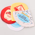 Four different types of cheese coasters with labels on a light gray background