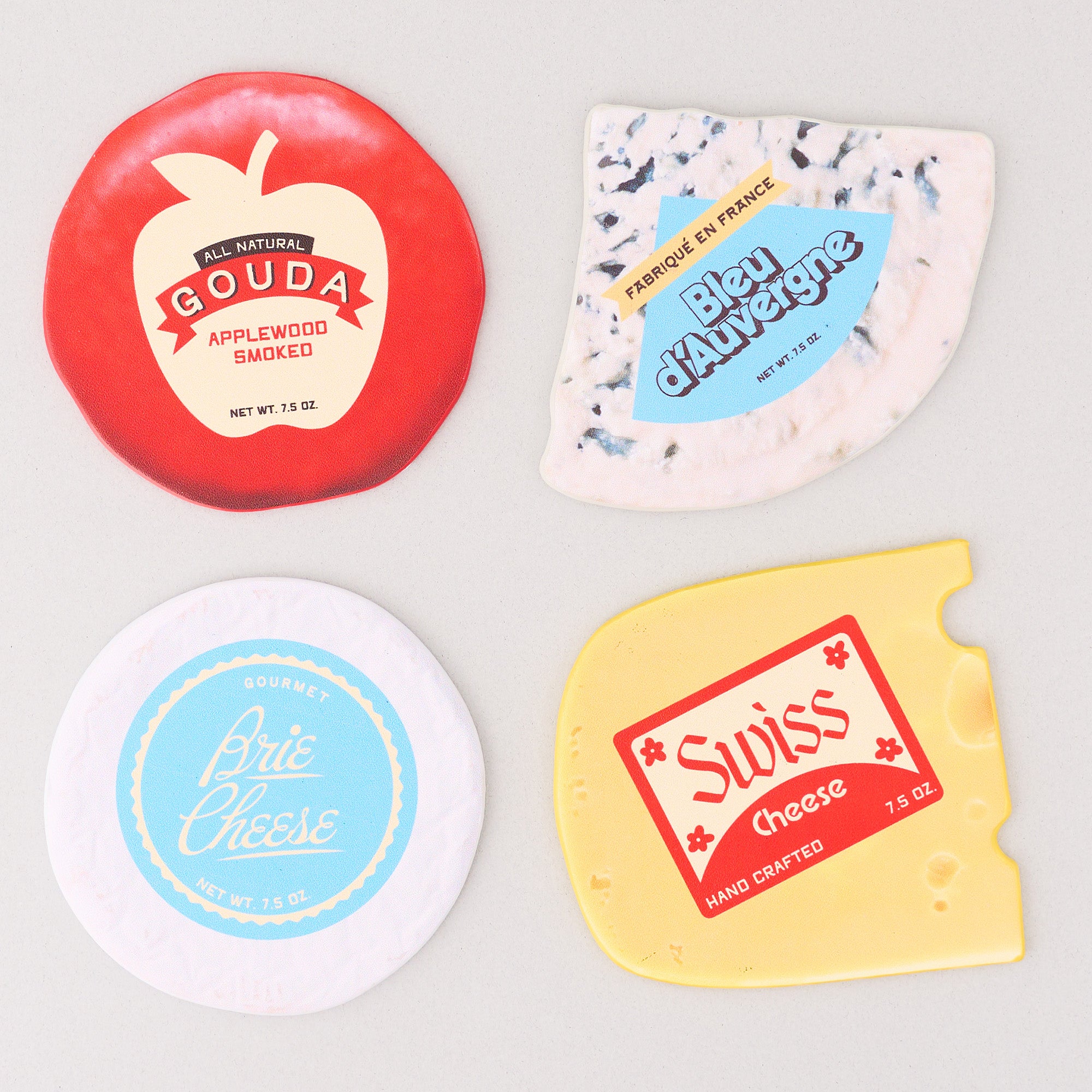 Flattened four different types of cheese coasters with labels on a light gray background