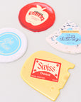 Collection of cheese-themed coasters on a light gray background