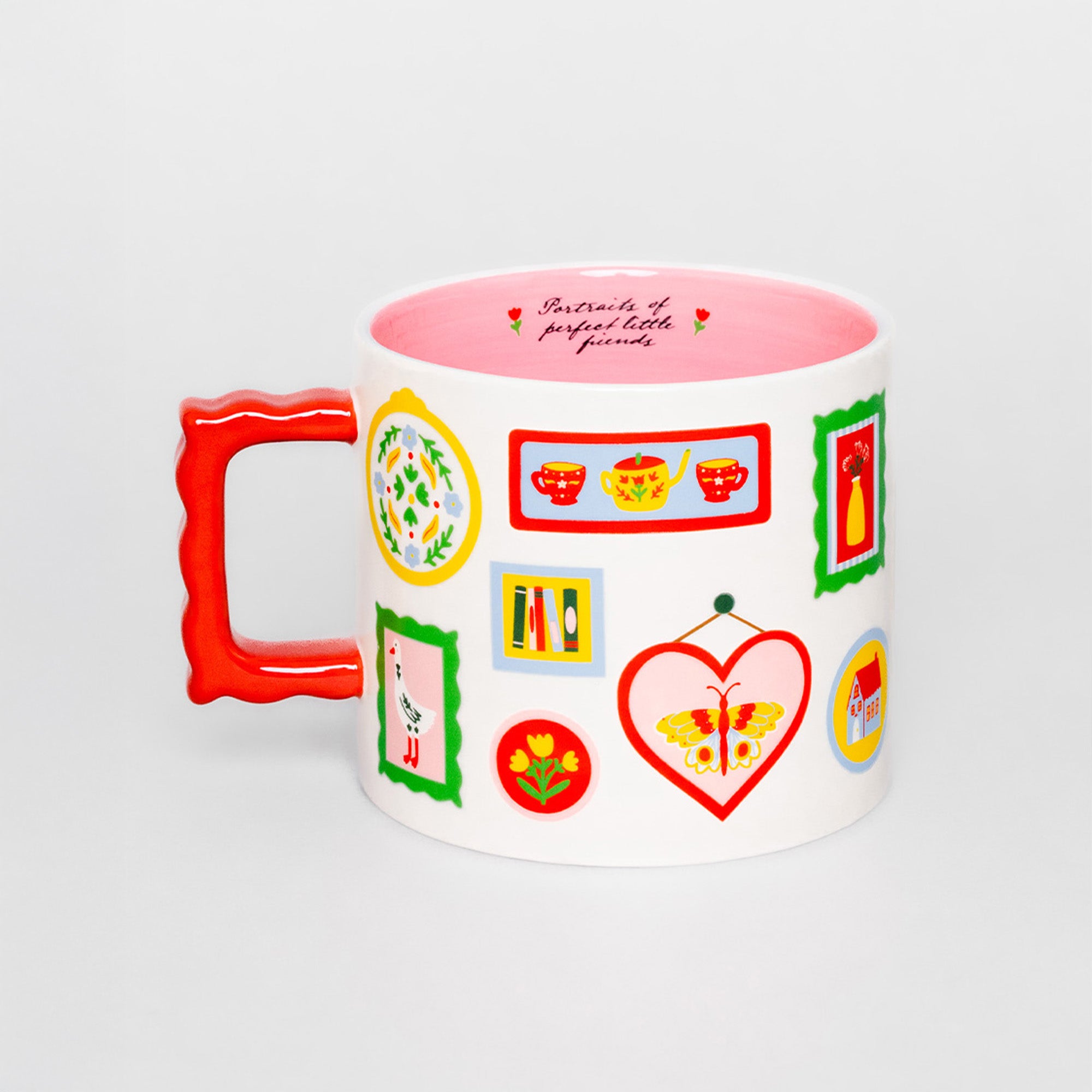 A white ceramic mug with a bright red handle and a colorful collection of illustrated tea-themed icons on the side, featuring a pink interior and the text 'Portraits of perfect little friends' printed inside.