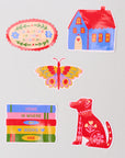Set of colorful stickers including a house, butterfly, books, and dog on a light gray background.
