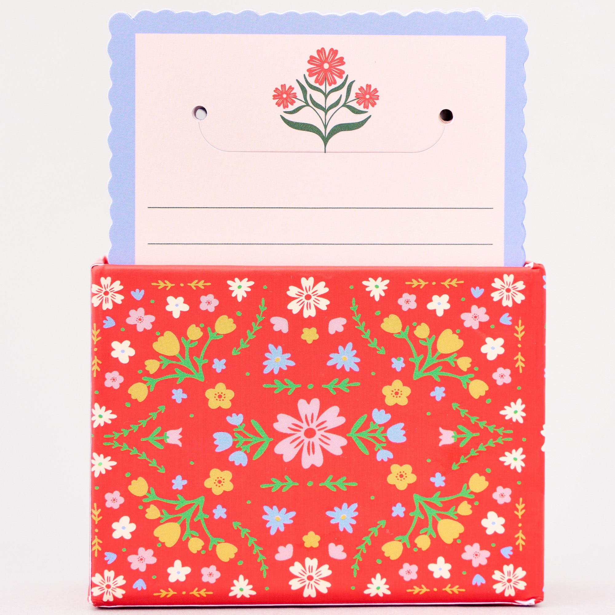 Floral-patterned card holder with a card featuring a flower design on a white background