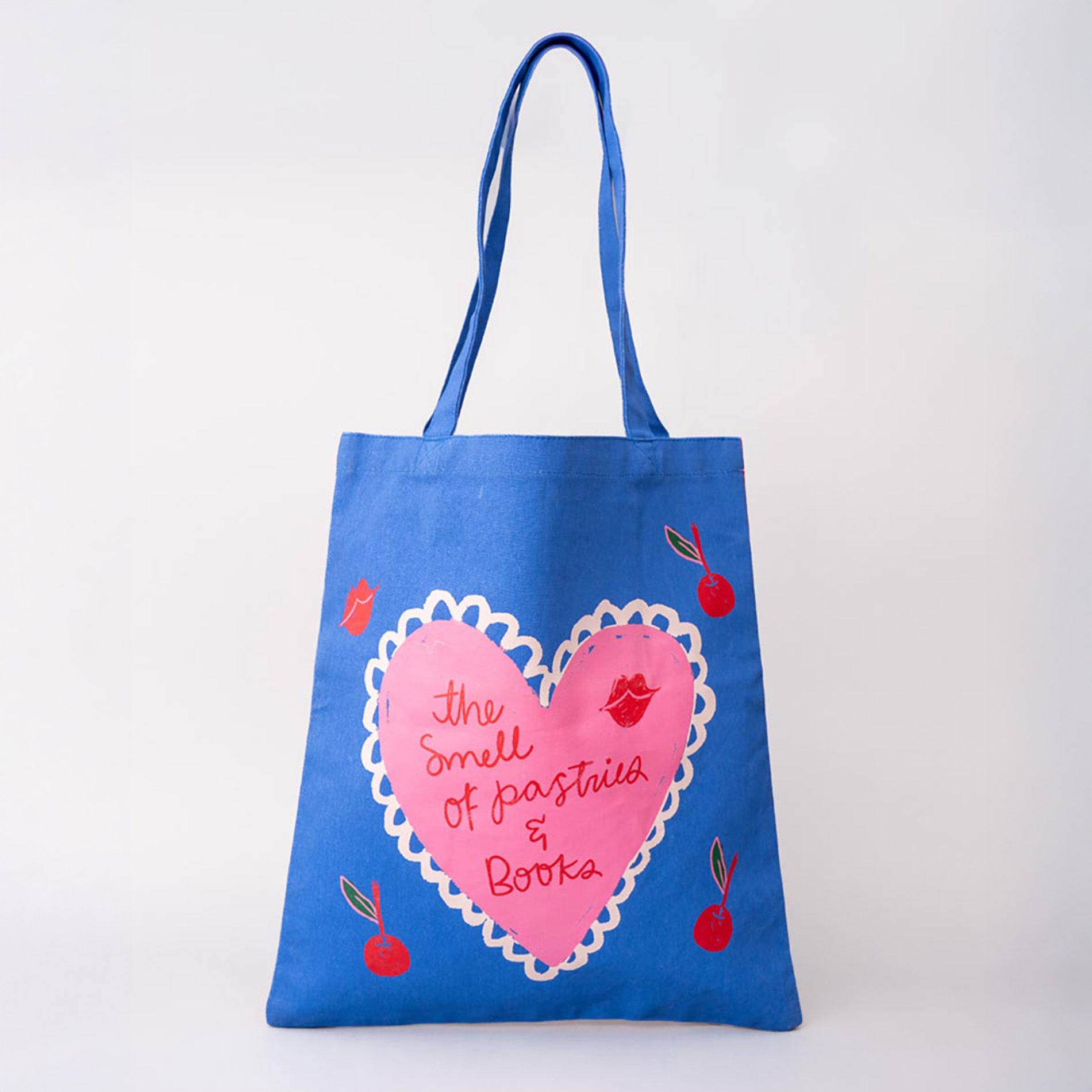 Blue tote bag with pink heart design and text on a white background