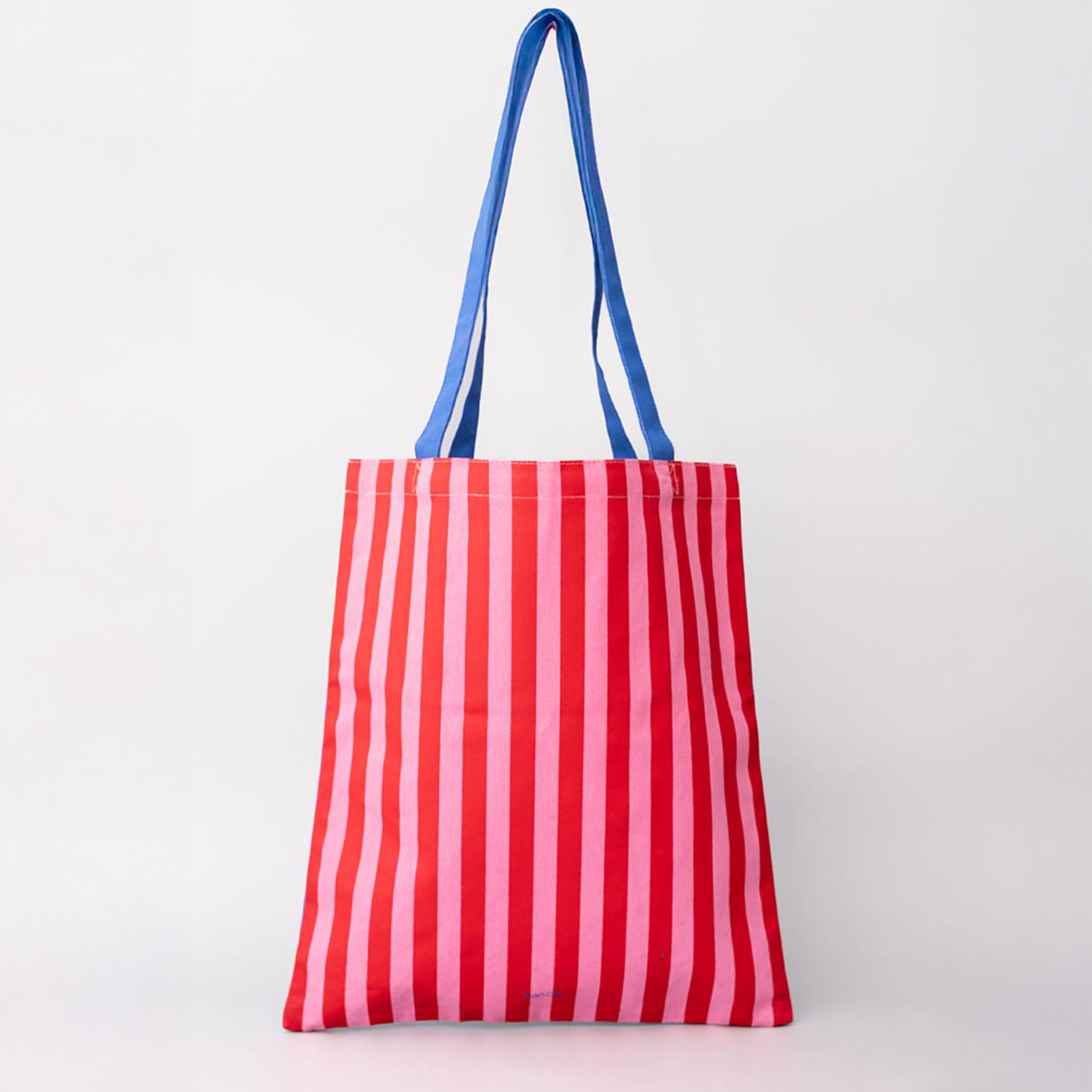 Red and white striped tote bag with blue handles on a light gray background