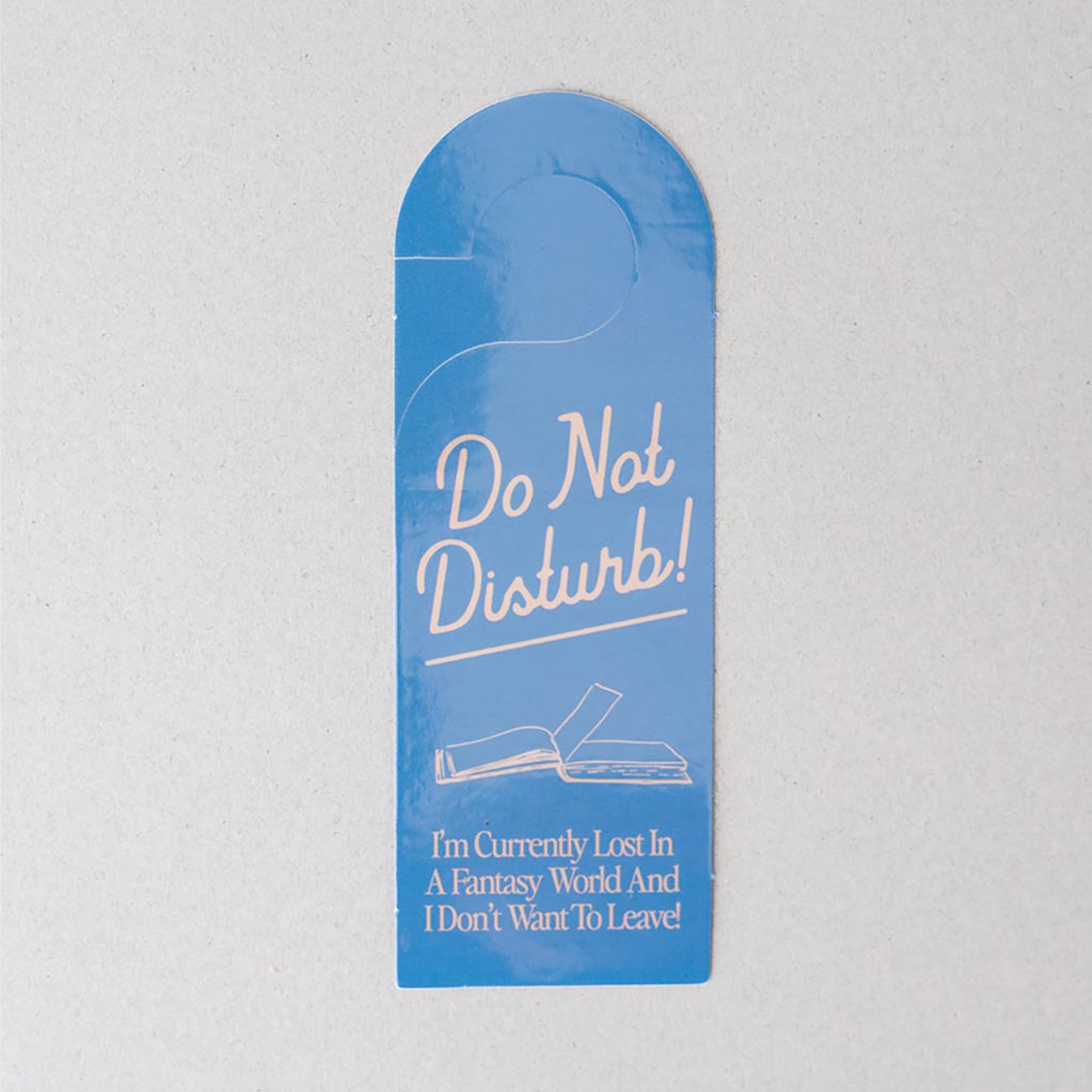 Blue door hanger with 'Do Not Disturb' message on a gray background
