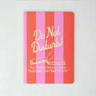 Notebook with pink and red striped cover and 'Do Not Disturb!' text on a white background