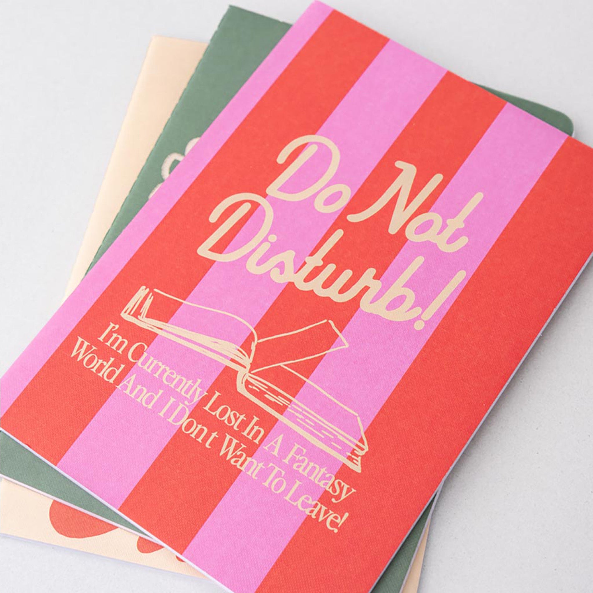 Notebook with 'Do Not Disturb' text and design on a light gray background