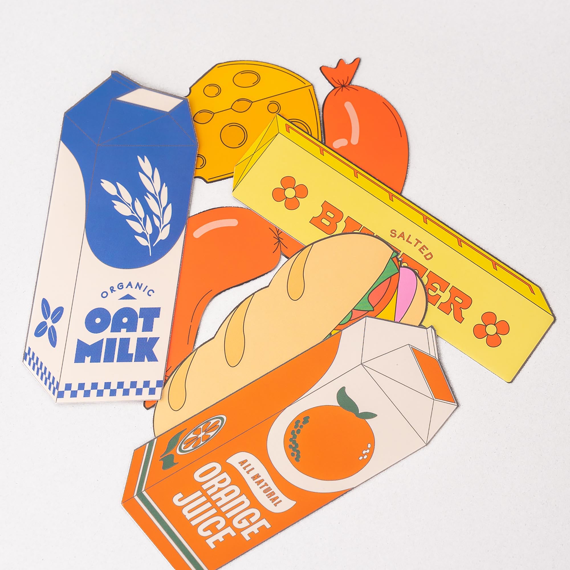 Illustrations of oat milk, orange juice, and a bar of butter on a white background
