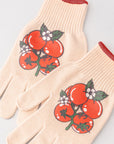 Pair of beige gardening gloves with red tomato design on a light gray background