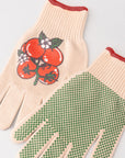 Beige gardening gloves with tomato design on one glove, on a light gray background