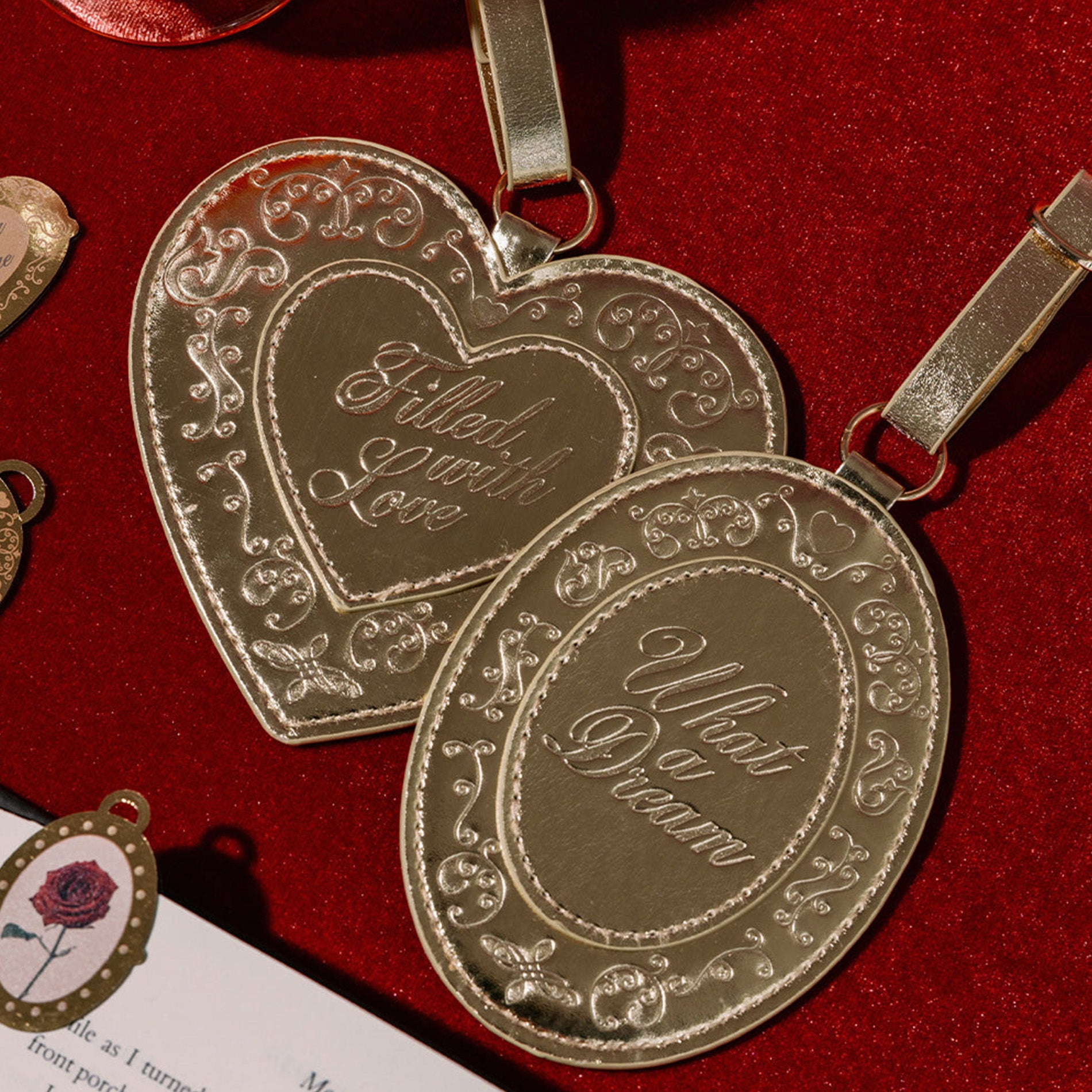 Gold heart-shaped luggage tag with engraved text on a red background
