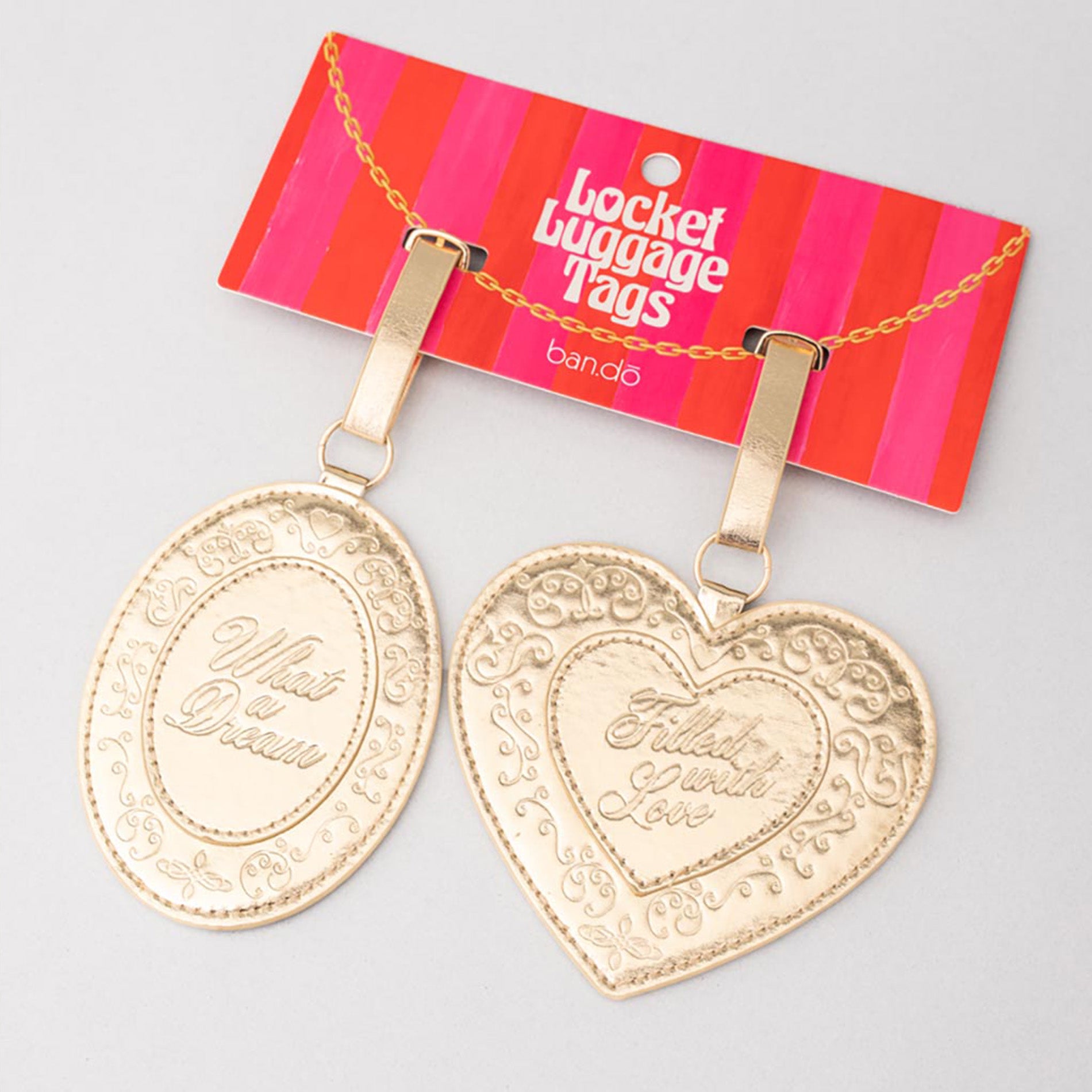Gold luggage tags with 'Filled with Love' text on a striped bandit packaging background