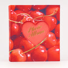 Photo album with red cherries and a heart-shaped cutout displaying 'Photo Album' text.