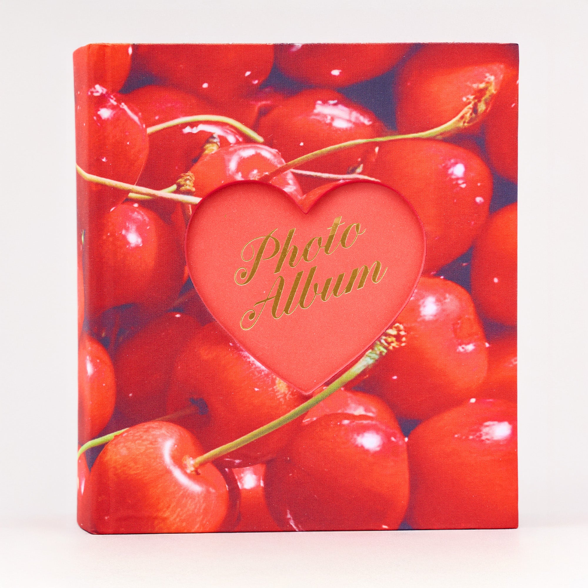 Photo album with red cherries and a heart-shaped cutout displaying 'Photo Album' text.