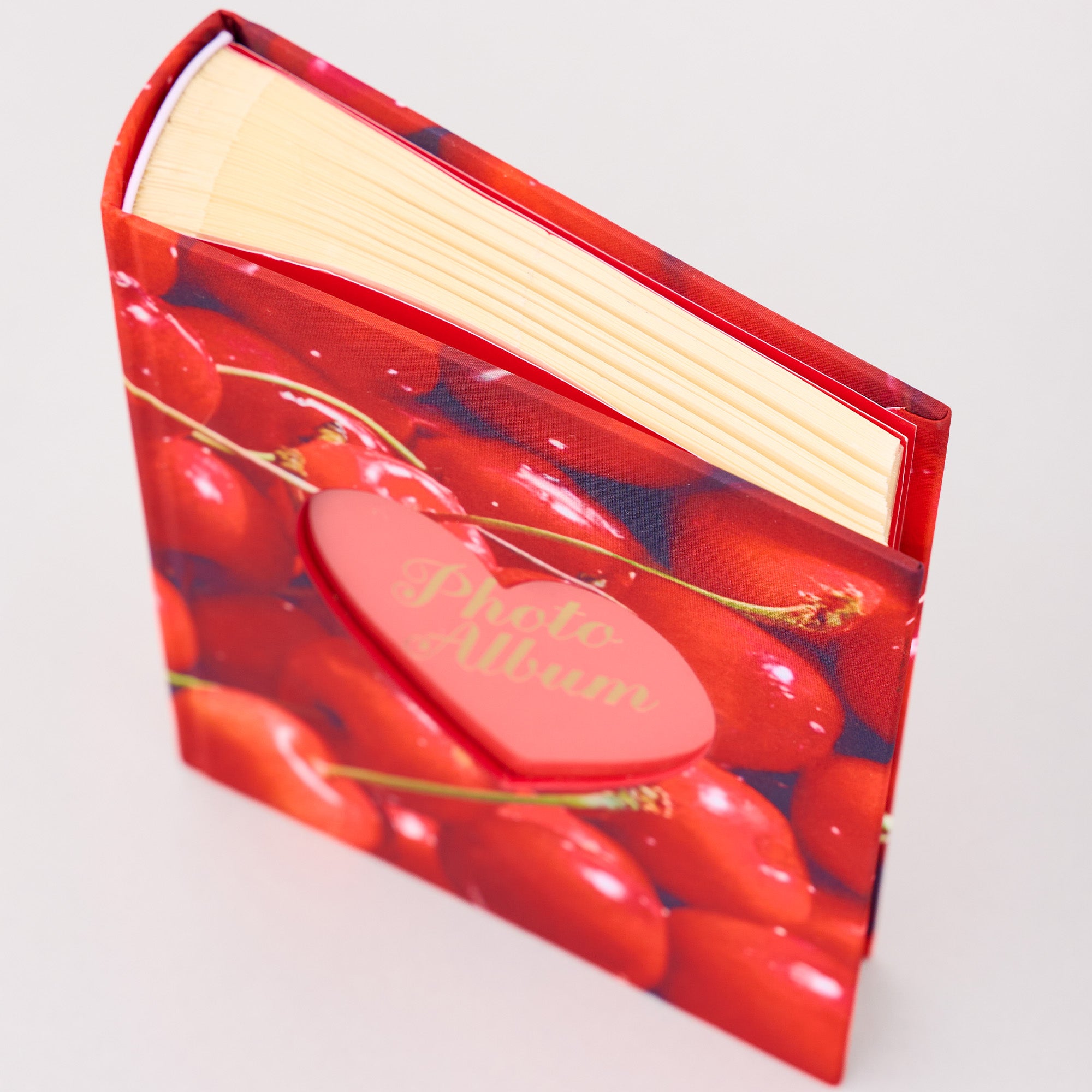 Red photo album with cherry design on a white background